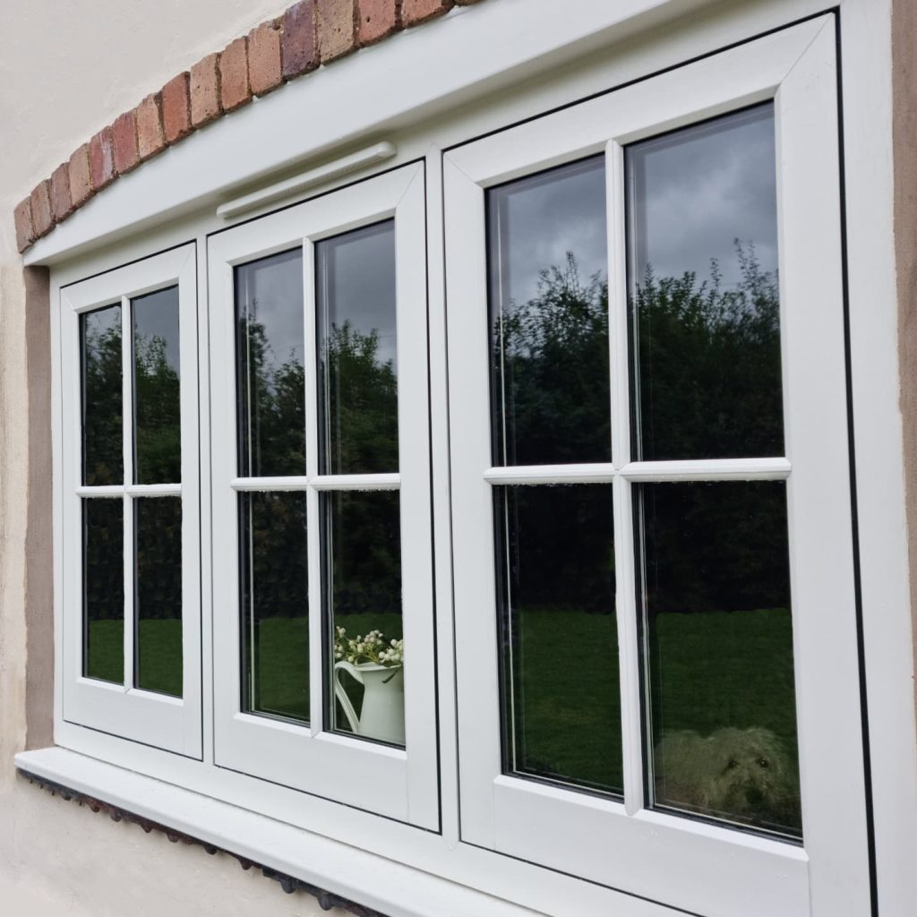 White flush casement windows with astragal bars.