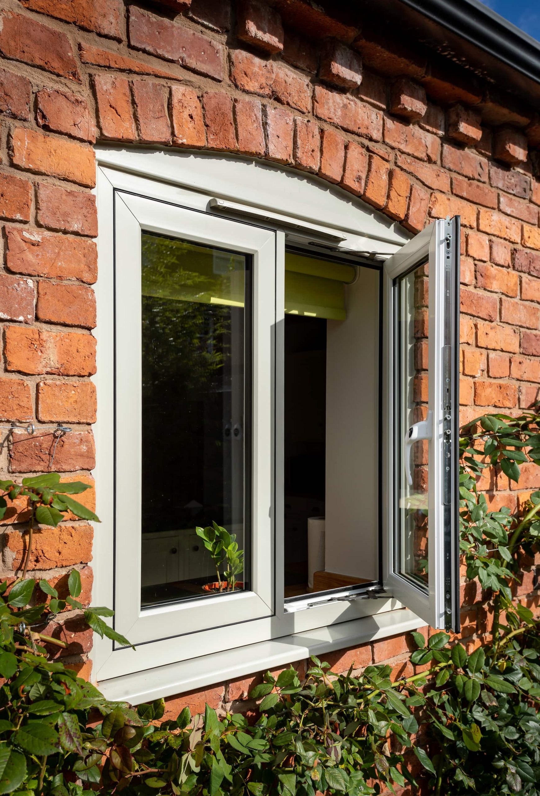 White flush casement windows with astragal bars.