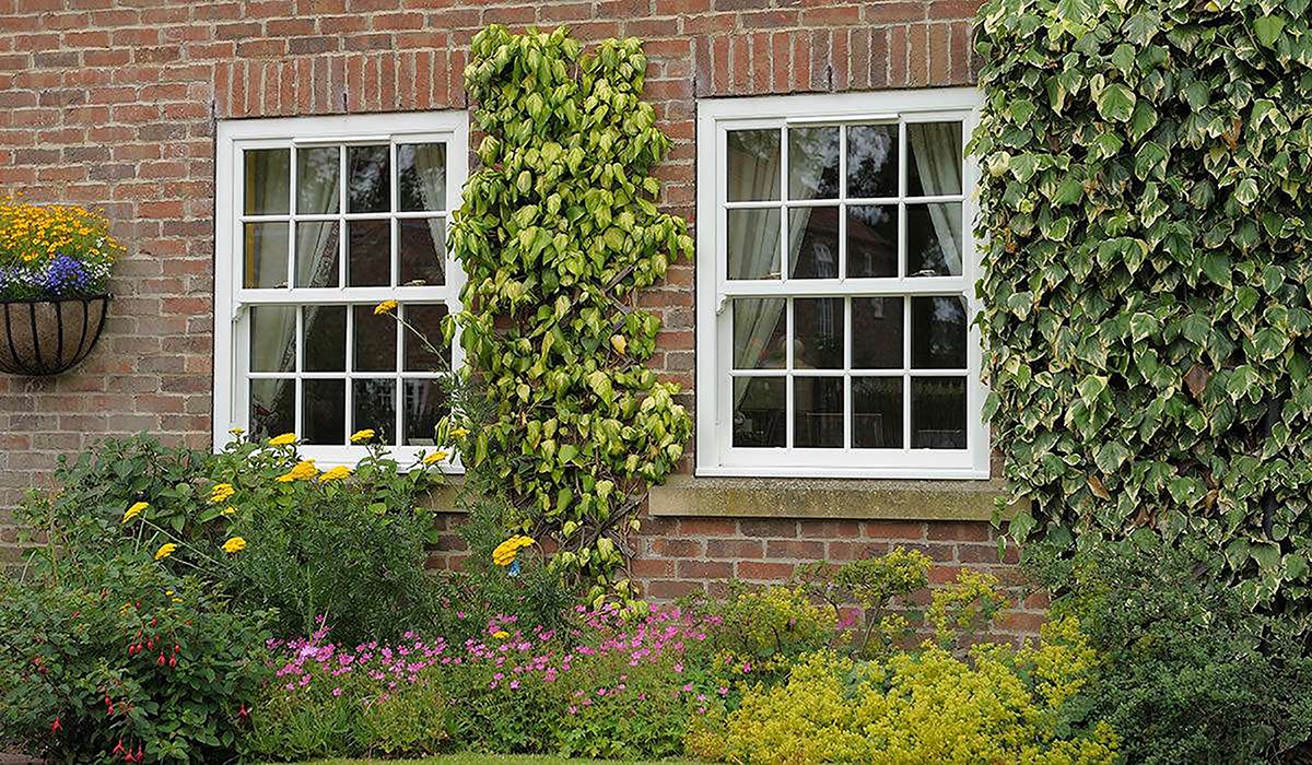 White uPVC sliding sash windows for a home in Wiltshire.